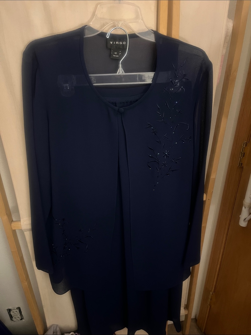 Virgo Navy Long Sleeve Tunic with Floral Embellishment includes navy skirt.